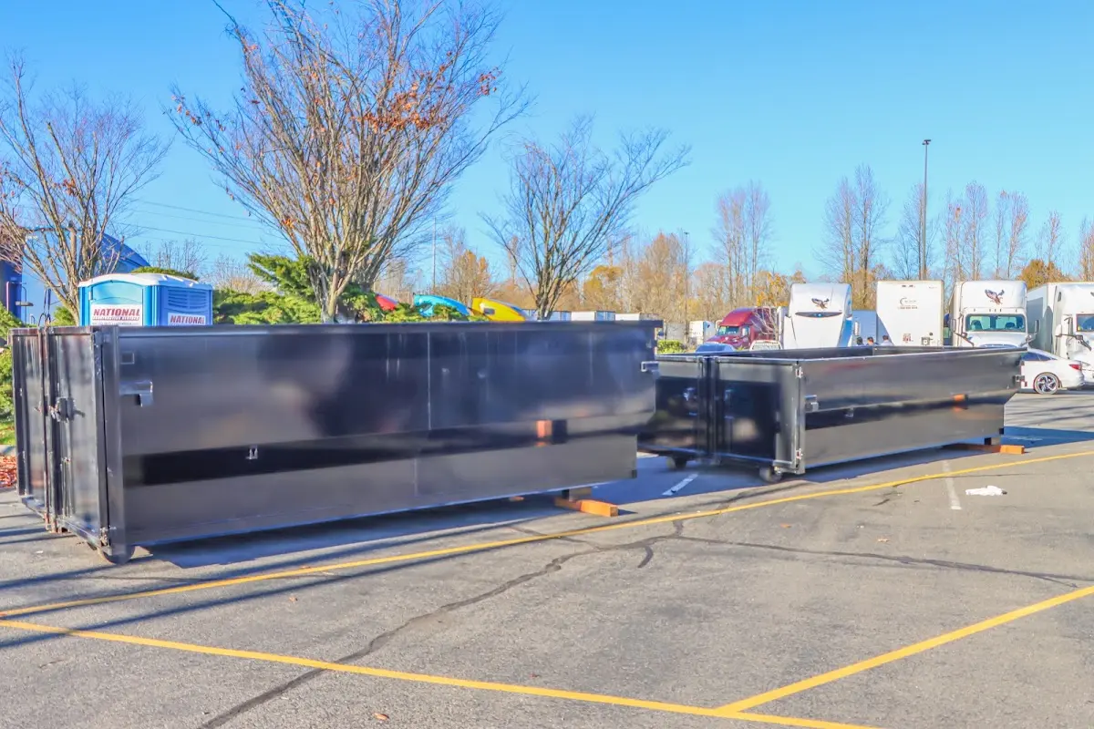 Professional dumpster rental service with roll-off container on residential driveway in Coldwater